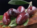 Close up of kalamon olives on wooden board