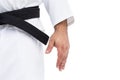 Close-up of karate black belt on white uniform