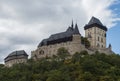 Close up Karlstejn gothic state castle near Prague, the most famous castle in Czech Republic with autumn colored trees. Blue sky