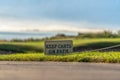 Close up of a Keep Carts On Path sign beside the paved pathway of a golf course