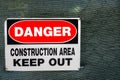 Danger sign on the fence surrounding a construction zone Royalty Free Stock Photo