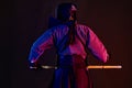 Close up. Kendo fighter wearing in an armor, traditional kimono, helmet practicing martial art, shinai bamboo sword