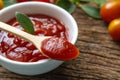 Close up of ketchup and tomatoes placed on a wooden background Royalty Free Stock Photo