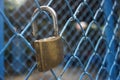 Close up a key lock hook on iron wire gates and water drop of rain with blur background,selective focus,filtered image Royalty Free Stock Photo