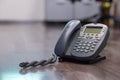 Close Up keypad number analog phone is placed on a wooden floor in the office