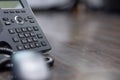 Close Up keypad number Black ip phone is placed on a wooden floor in the office