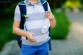 Close-up of kid boy with medical mask and backpack or satchel. Schoolkid on way to school. child outdoors. Back to