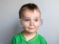 Close up the kid face wearing a protective glasses. Child face in safety goggles Royalty Free Stock Photo