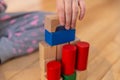 Close up of a Kid hand Playing with Colourful Blocks