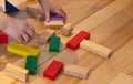 Close up of a Kid hand Playing with Colourful Blocks