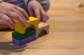 Close up of a Kid hand Playing with Colourful Blocks