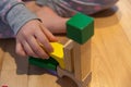 Close up of a Kid hand Playing with Colourful Blocks