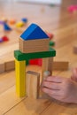 Close up of a Kid hand Playing with Colourful Blocks