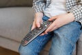 Close-up kid hands holding TV remote controller. Boy without parental control watching television