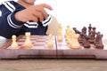 Close-up of kid playing chess on chessboard Royalty Free Stock Photo