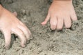 Close up kid`s hand and finger, play and learn at the beach