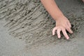 Close up kid`s hand and fingers, play and learn at the beach