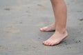 Close up kid`s legs, play and learn at the beach