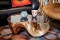 close-up of a kidney-shaped coffee table with a metallic ashtray and a vinyl record cover