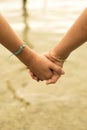 Close up of kids holding hands on beach concept Royalty Free Stock Photo