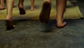 Close up for kids legs running barefoot on yellow mat, rear view. Scene. Children legs running indoors without shoes on Royalty Free Stock Photo