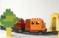 Close up kids toys composition with plastic toy train on railroad and tree. Royalty Free Stock Photo