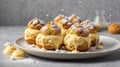 Close up of King profiterole with custard sprinkled with powdered sugar served on a white