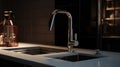 Close-up of kitchen countertop with built-in sink, metallic faucet on the foreground. Black tile backsplash on the