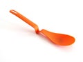 Close up of kitchen silicone spatula isolated. Stylish modern orange plastic spoon on white background. Accessories and Household Royalty Free Stock Photo