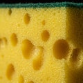 Close-up of a kitchen sponge showing a textured yellow surface with large and small Royalty Free Stock Photo