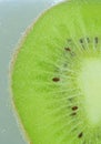 Close-up of kiwi fruit in liquid with bubbles. Slice of green ripe kiwi fruit in sparkling water. Juicy kiwi fruit in Royalty Free Stock Photo