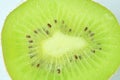 Close-up of kiwi fruit in liquid with bubbles. Slice of green ripe kiwi fruit in sparkling water. Juicy kiwi fruit in Royalty Free Stock Photo