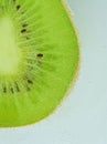 Close-up of kiwi fruit in liquid with bubbles. Slice of green ripe kiwi fruit in sparkling water. Juicy kiwi fruit in Royalty Free Stock Photo