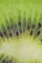 Close-up of a kiwi fruit slice in liquid with bubbles. Slice of ripe kiwi fruit in water. Close-up of fresh kiwi slice Royalty Free Stock Photo