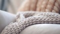 A close up of a knitted blanket on a couch, AI