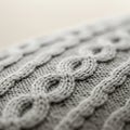Close-up of a knitted fabric with a cable knit pattern, featuring interlocking loops and Royalty Free Stock Photo