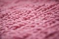 Close up of knitting dirty-pink textured wool background, vintage style