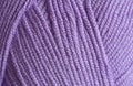 Close-up, knitting texture. The violet thread and knitting.