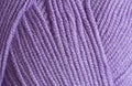 Close-up, knitting texture. The violet thread and knitting. Royalty Free Stock Photo