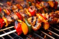 Close-up of Kung Pao chicken skewers on a grill with charred red bell peppers and brushed with sweet and spicy sauce