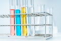 Close up of  lab test tubes fill with red, blue, yellow and clear liquid in the tube rack Royalty Free Stock Photo