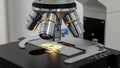 Microscope has multiple objective lenses with magnifications indicated Royalty Free Stock Photo
