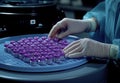 Close-up of a laboratory technician handling vaccine vials