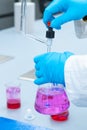 Close up laboratory worker uses a titration method of analysis to study chemical properties of the water sample Royalty Free Stock Photo
