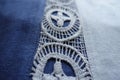 Closeup of lace on blue linen fabric Royalty Free Stock Photo