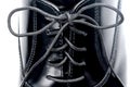 Close up of laces on a black leather shoe