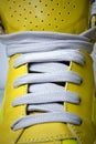 Close-up laces on the yellow boots