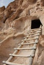 Close-up of ladder leading up to ancient cliff dwelling entrance at Bandelier National Monument in New Mexico desert Royalty Free Stock Photo