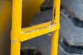 Close up of the ladder with peeling yellow paint of a construction machinery Royalty Free Stock Photo