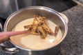 Close-up of a ladle taking out cod to remove the salt with milk Royalty Free Stock Photo